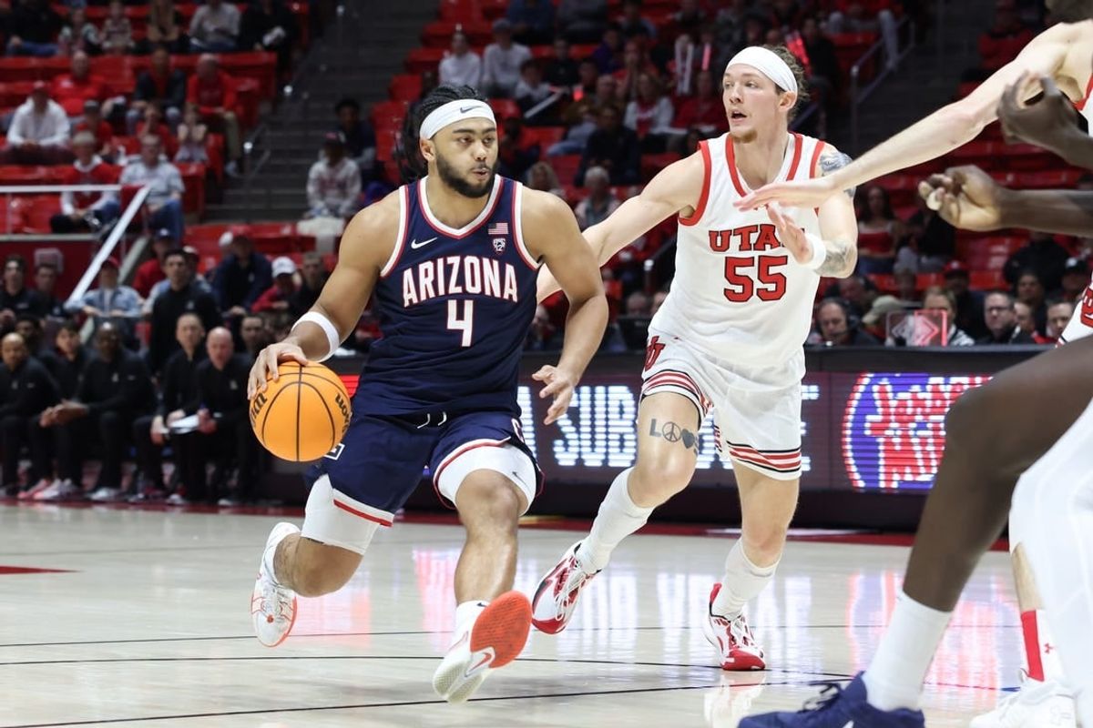 Feb 8, 2024; Salt Lake City, Utah, USA; Arizona Wildcats guard Kylan Boswell (4) brings the ball up the court against Utah Utes guard Gabe Madsen (55) during the first half at Jon M. Huntsman Center.