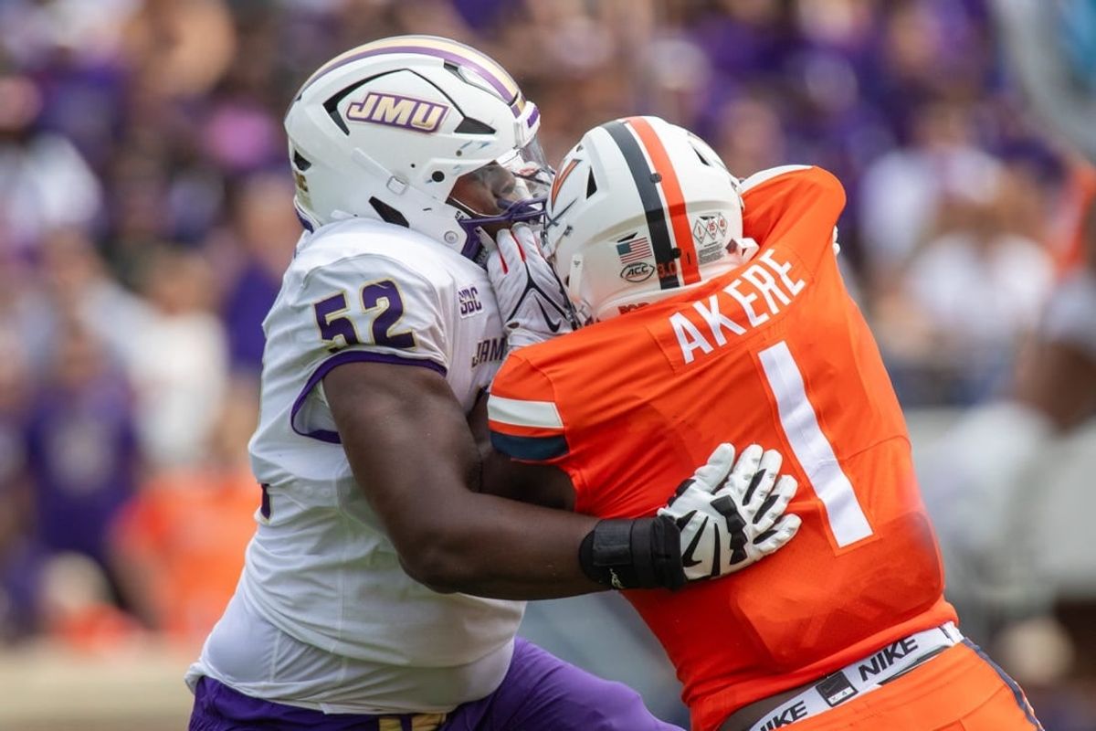 September 9, 22023 in Charlottesville, Virginia; James Madison Dukes offensive lineman Tyshawn Wyatt (52) blocks Virginia Cavaliers defensive end Paul Akere (1) during the first half of the game at Scott Stadium.