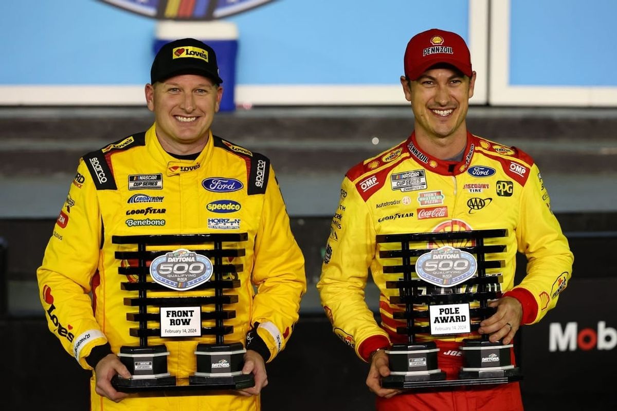 Feb 14, 2024; Daytona Beach, Florida, USA; NASCAR Cup Series driver Joey Logano (right) poses with the pole award with driver Michael McDowell (left), qualified second, after qualifying for the Daytona 500 at Daytona International Speedway.