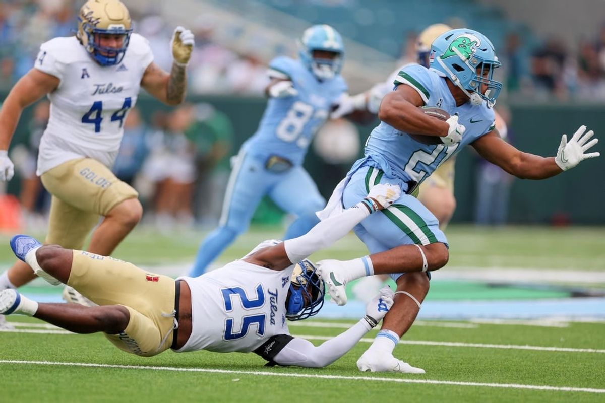 Nov 11, 2023; New Orleans, Louisiana, USA; Tulsa Golden Hurricane safety Jaise Oliver (25) tries to tackler Tulane Green Wave running back Makhi Hughes (21) in first quarter action at Yulman Stadium.