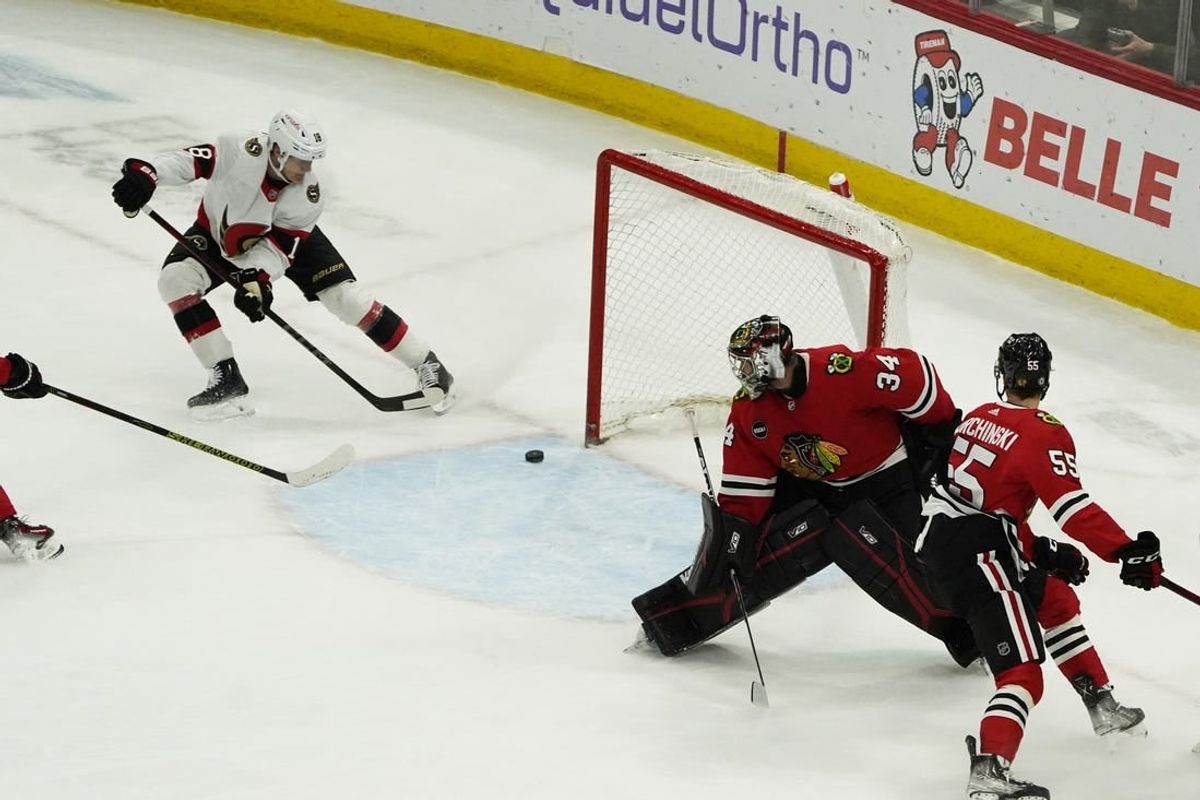 Feb 17, 2024; Chicago, Illinois, USA; Ottawa Senators center Tim Stutzle (18) scores a goal on Chicago Blackhawks goalie Petr Mrazek (34) during the first period at United Center.
