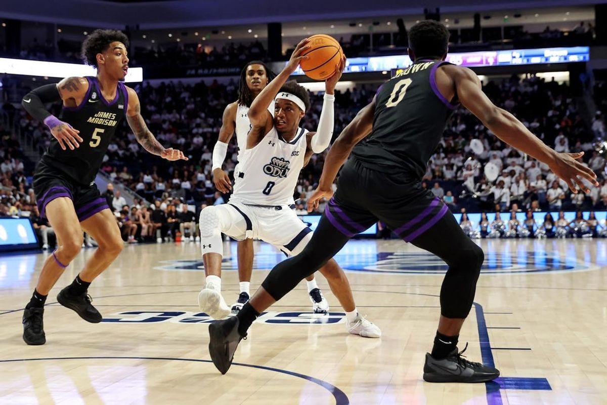 Dec 9, 2023; Norfolk, Virginia, USA; Old Dominion Monarchs guard Vasean Allette (0) drives to the basket against James Madison Dukes guard Terrence Edwards (5) and guard Xavier Brown (0) during the second half at Chartway Arena at the Ted Constant Convocation Center.