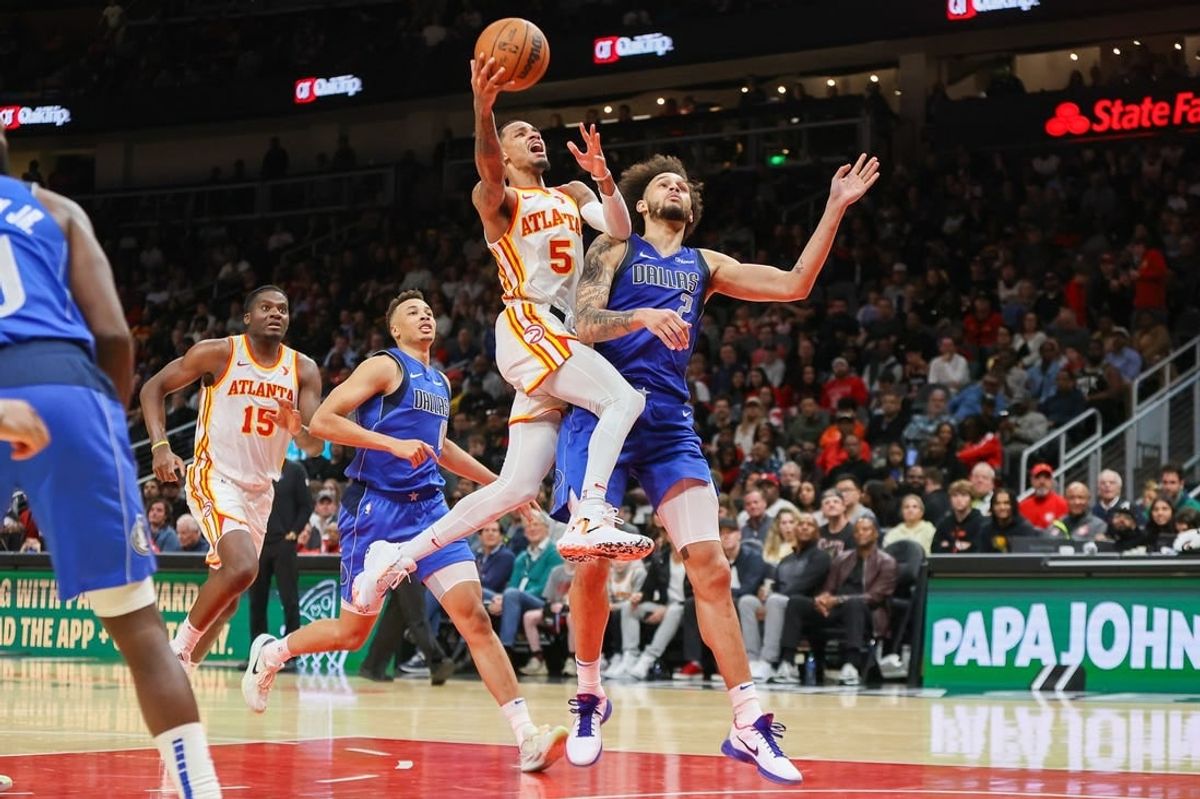Jan 26, 2024; Atlanta, Georgia, USA; Atlanta Hawks guard Dejounte Murray (5) shoots past Dallas Mavericks center Dereck Lively II (2) in the second half at State Farm Arena.