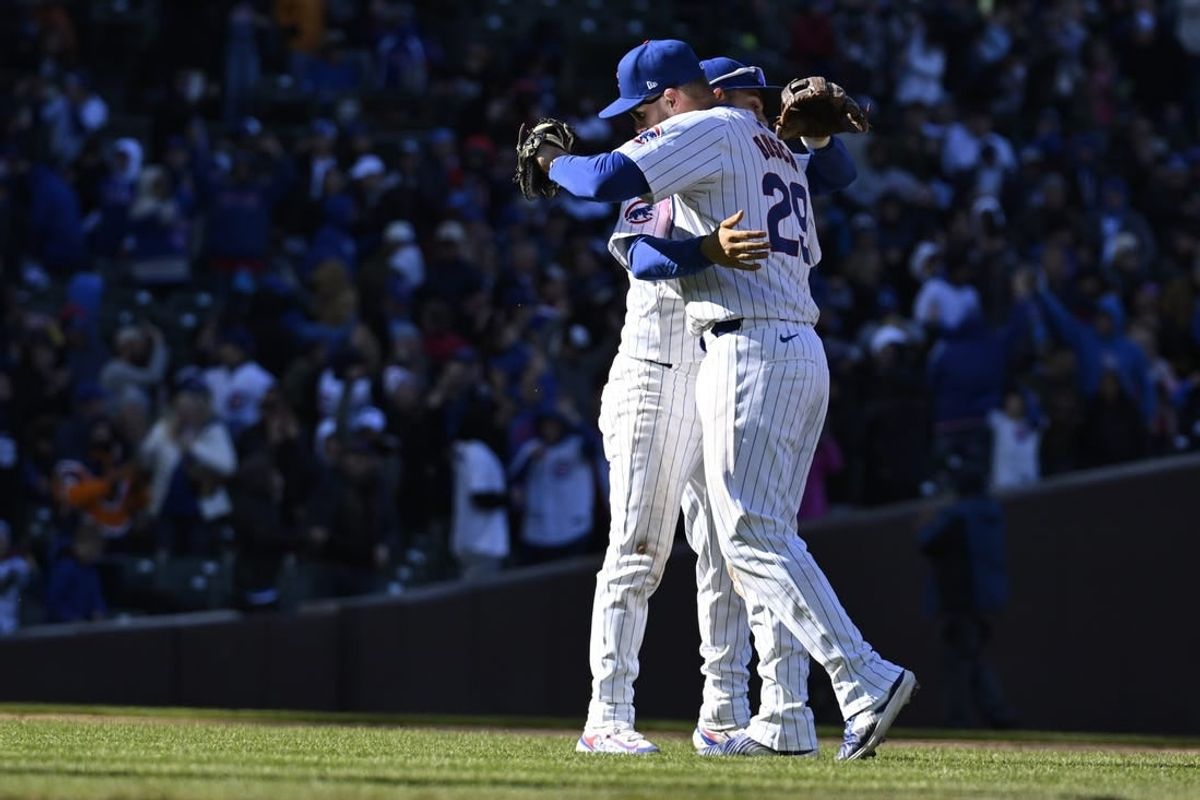 Apr 5, 2024; Chicago, Illinois, USA;  Chicago Cubs first base Michael Busch (29) and third base Nick Madrigal celebrate after defeating the Los Angeles Dodgers at Wrigley Field.