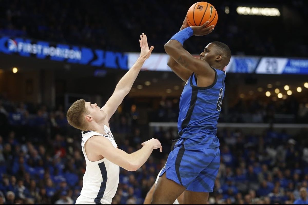 Dec 19, 2023; Memphis, Tennessee, USA; Memphis Tigers forward David Jones (8) shoots as Virginia Cavaliers guard Isaac McKneely (11) defends during the first half at FedExForum.