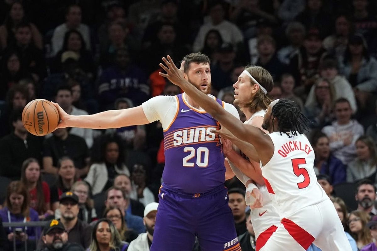 Mar 7, 2024; Phoenix, Arizona, USA; Phoenix Suns center Jusuf Nurkic (20) protects the ball from Toronto Raptors forward Kelly Olynyk (41) and Toronto Raptors guard Immanuel Quickley (5) during the first half at Footprint Center.
