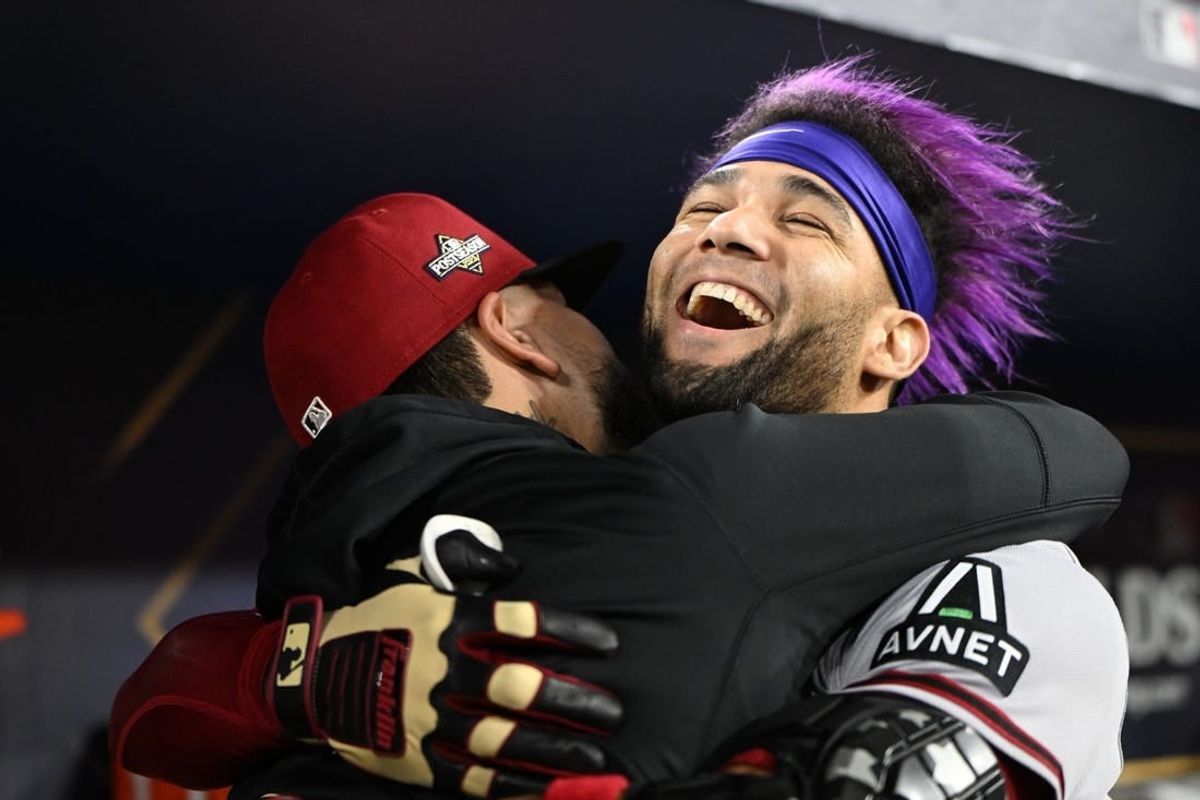 Oct 9, 2023; Los Angeles, California, USA; Arizona Diamondbacks left fielder Lourdes Gurriel Jr. (12) reacts with catcher Jose Herrera (11) after hitting a home run during the sixth inning for game two of the NLDS for the 2023 MLB playoffs at Dodger Stadium.