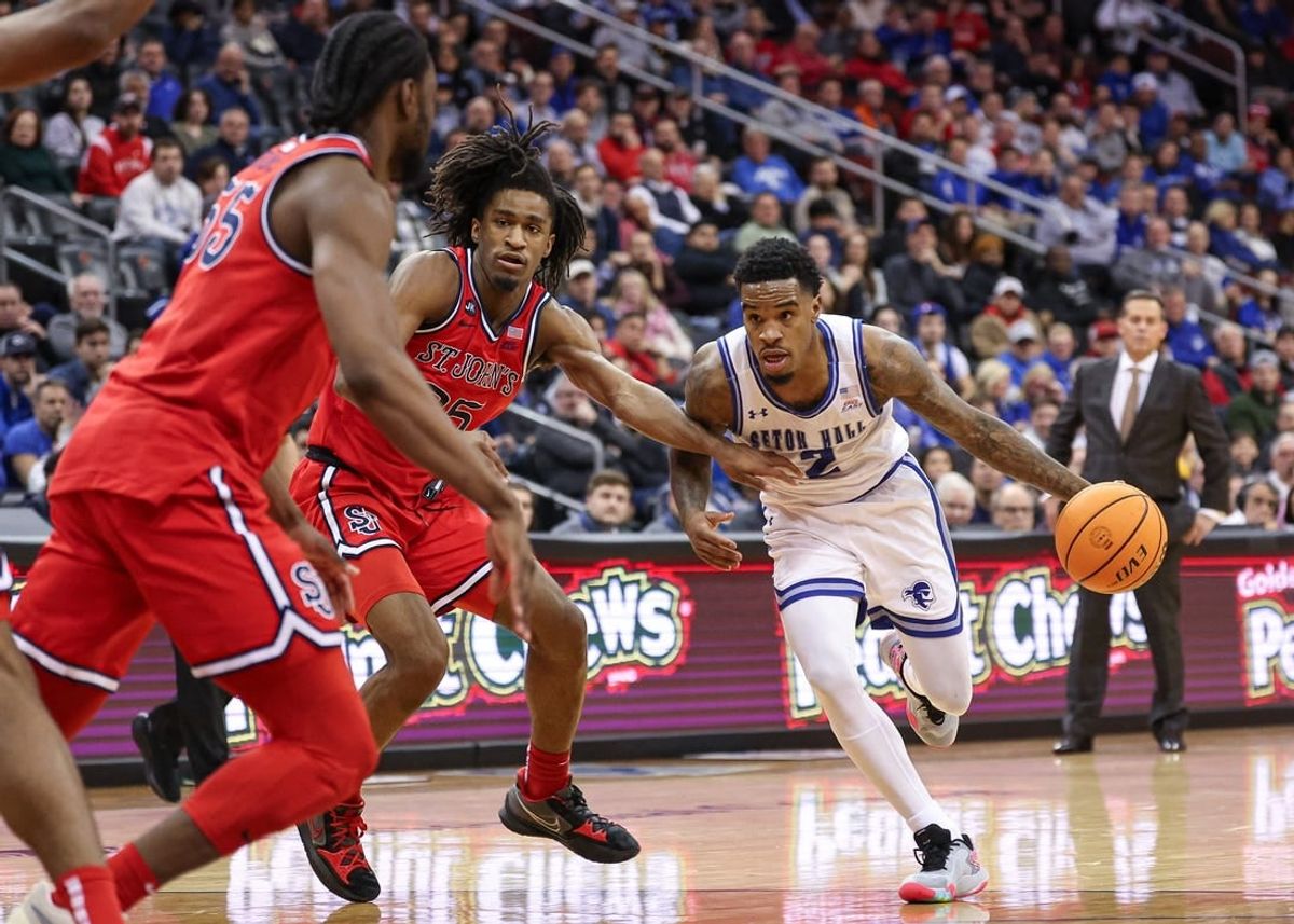Jan 16, 2024; Newark, New Jersey, USA; Seton Hall Pirates guard Al-Amir Dawes (2) dribbles as St. John's Red Storm forward Glenn Taylor Jr. (35) and forward Drissa Traore (55) defend during the second half at Prudential Center.