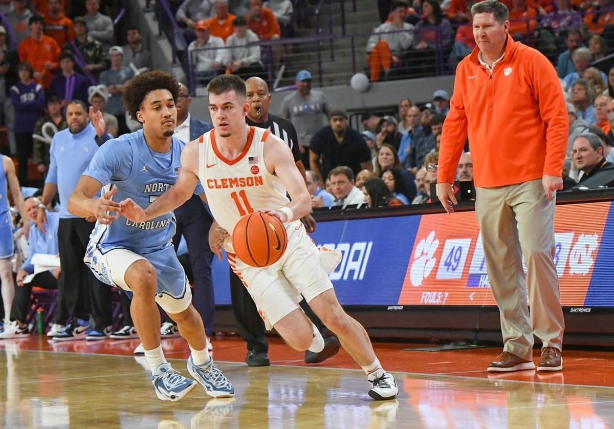 Jan 6, 2024; Clemson, South Carolina, USA; Clemson graduate Joseph Girard III  dribbles near University of North Carolina guard Seth Trimble (7) during the second half at Littlejohn Coliseum.