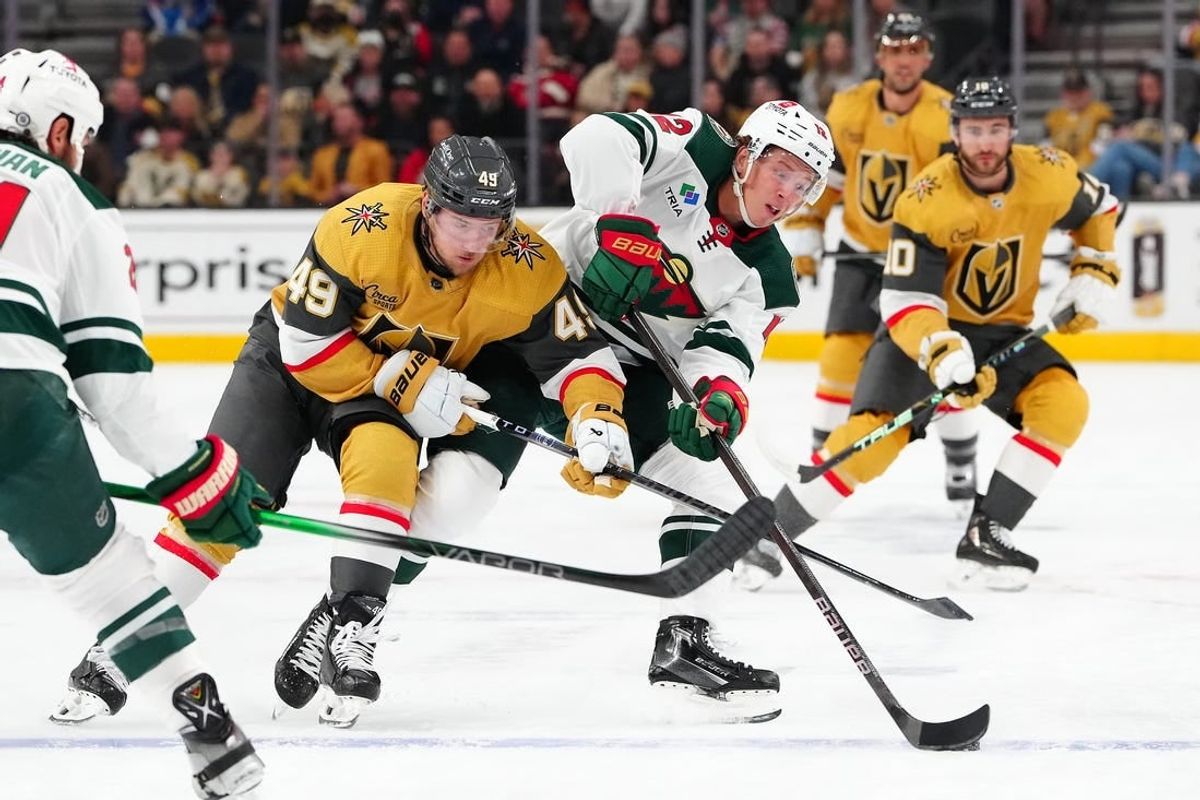 Feb 12, 2024; Las Vegas, Nevada, USA; Minnesota Wild left wing Matt Boldy (12) keeps the puck away from Vegas Golden Knights center Ivan Barbashev (49) during the first period at T-Mobile Arena.