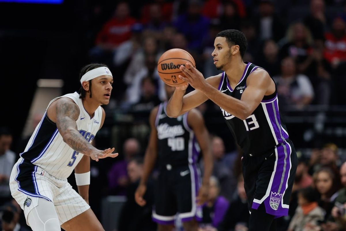 Jan 3, 2024; Sacramento, California, USA; Sacramento Kings forward Keegan Murray (13) looks to pass the ball against Orlando Magic forward Paolo Banchero (5) during the first quarter at Golden 1 Center.