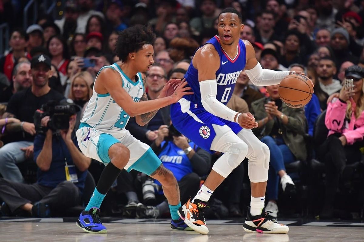 Dec 26, 2023; Los Angeles, California, USA; Los Angeles Clippers guard Russell Westbrook (0) moves the ball against Charlotte Hornets guard Nick Smith Jr. (8) during the first half at Crypto.com Arena.