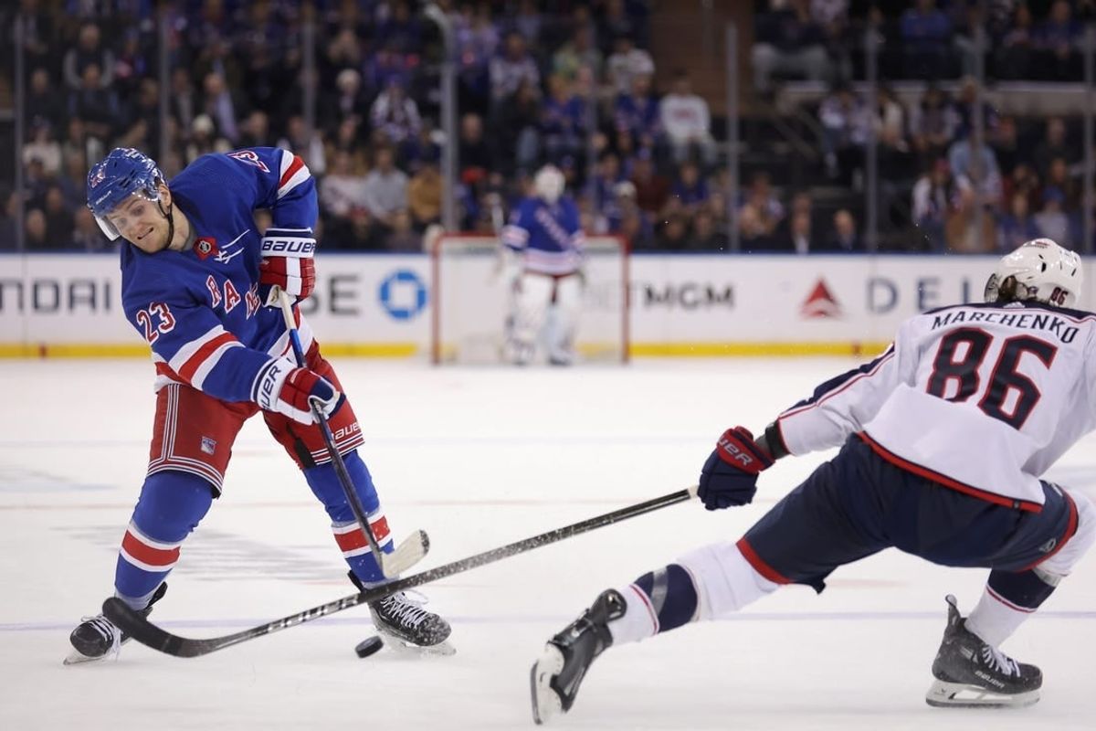 Feb 28, 2024; New York, New York, USA; New York Rangers defenseman Adam Fox (23) takes a shot against Columbus Blue Jackets right wing Kirill Marchenko (86) during the second period at Madison Square Garden.