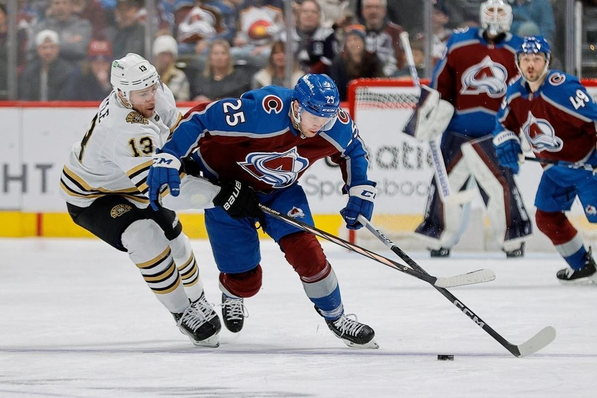 Jan 8, 2024; Denver, Colorado, USA; Colorado Avalanche right wing Logan O'Connor (25) and Boston Bruins center Charlie Coyle (13) battle for the puck in the second period at Ball Arena.