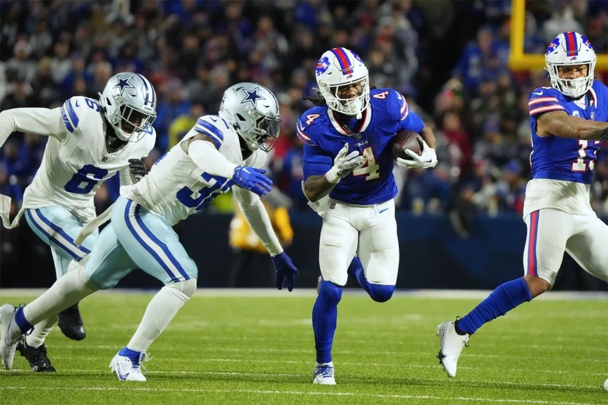 Dec 17, 2023; Orchard Park, New York, USA; Buffalo Bills running back James Cook (4) runs the ball pressured by Dallas Cowboys linebacker Rashaan Evans (32) in the first half at Highmark Stadium.