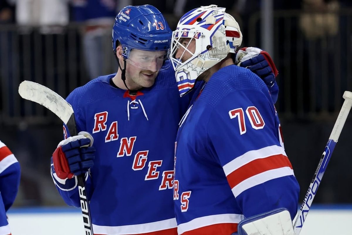 Nov 9, 2023; New York, New York, USA; New York Rangers left wing Alexis Lafreniere (13) celebrates with goaltender Louis Domingue (70) after defeating the Minnesota Wild at Madison Square Garden.