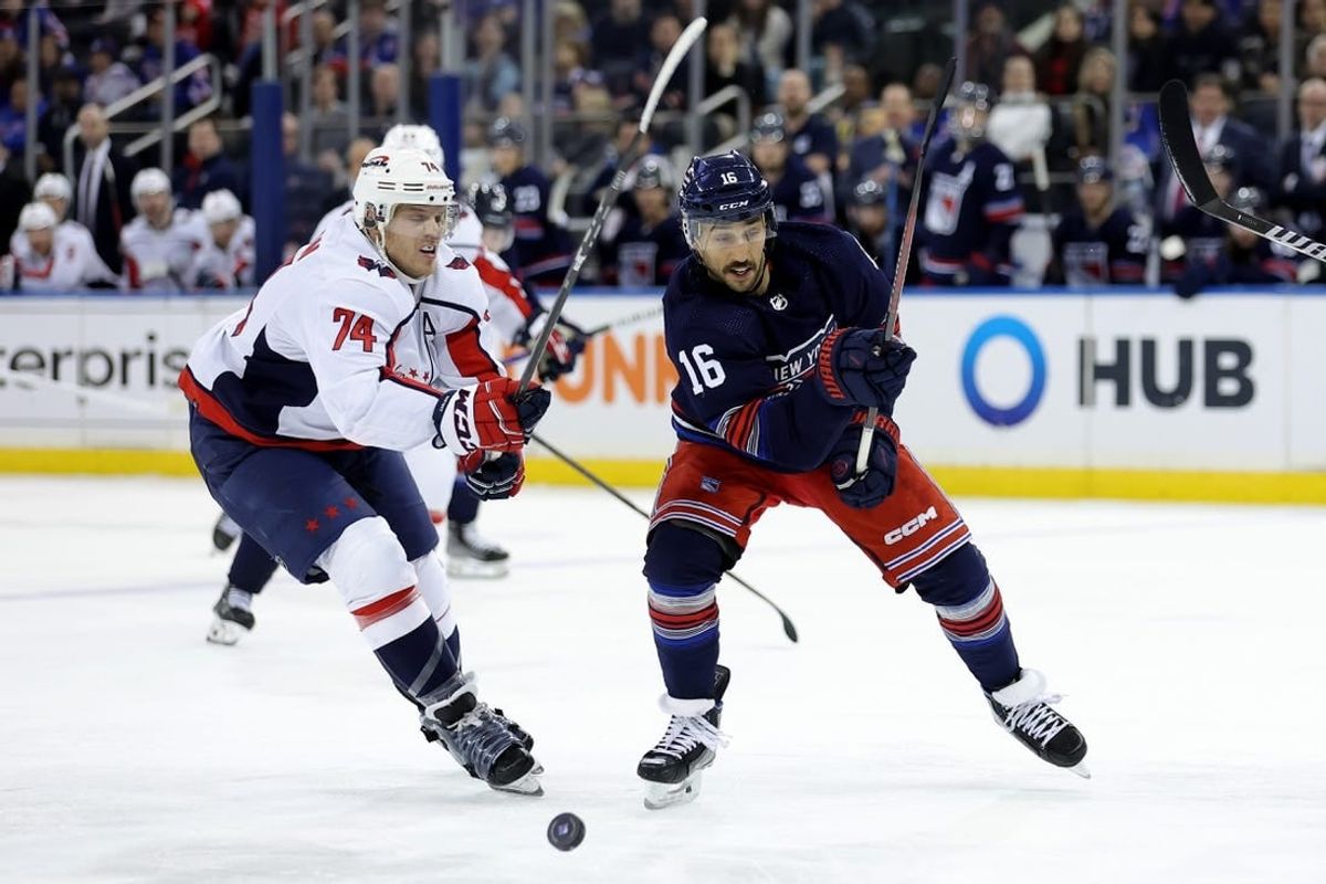 Jan 14, 2024; New York, New York, USA; New York Rangers center Vincent Trocheck (16) and Washington Capitals defenseman John Carlson (74) fight for the puck during the second period at Madison Square Garden.