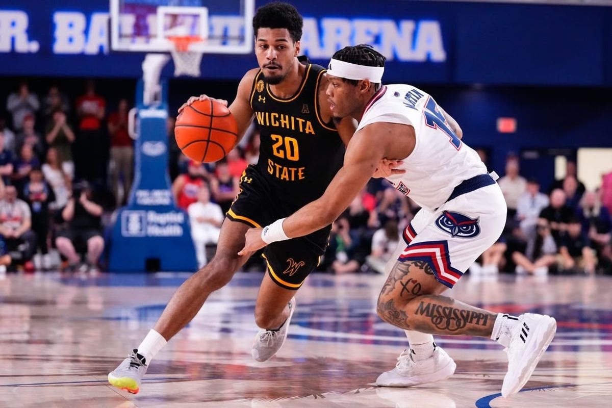 Jan 18, 2024; Boca Raton, Florida, USA; Wichita State Shockers guard Harlond Beverly (20) dribbles the ball against Florida Atlantic Owls guard Alijah Martin (15) during the first half at Eleanor R. Baldwin Arena.