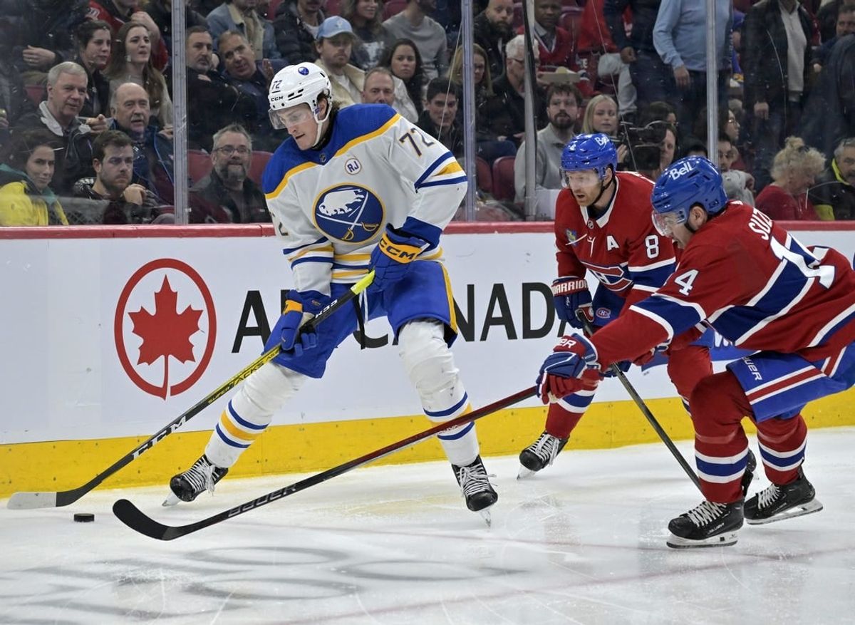 Feb 21, 2024; Montreal, Quebec, CAN; Buffalo Sabres forward Tage Thompson (72) plays the puck and Montreal Canadiens forward Nick Suzuki (14) defends during the second period at the Bell Centre.