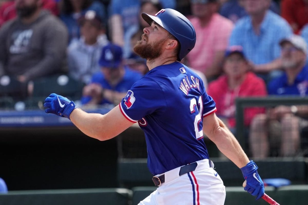 Mar 8, 2024; Surprise, Arizona, USA; Texas Rangers first baseman Jared Walsh (21) bats against the Kansas City Royals during the first inning at Surprise Stadium.