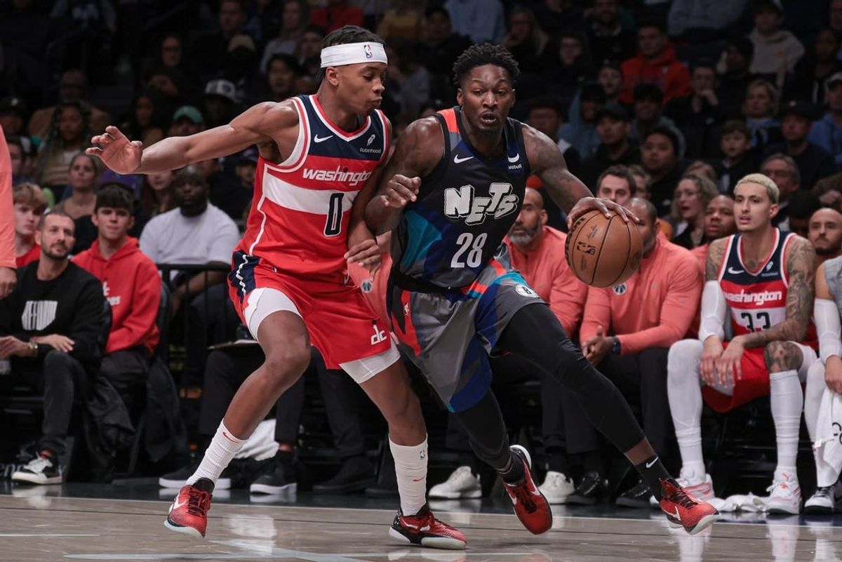 Nov 12, 2023; Brooklyn, New York, USA; Brooklyn Nets forward Dorian Finney-Smith (28) dribbles against Washington Wizards guard Bilal Coulibaly (0) during the half quarter at Barclays Center.