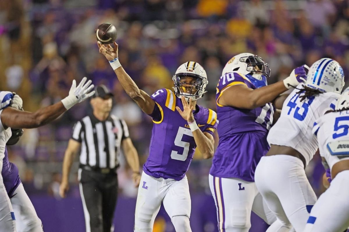 Nov 18, 2023; Baton Rouge, Louisiana, USA; LSU Tigers quarterback Jayden Daniels (5) throws a pass in the third quarter as offensive lineman Miles Frazier (70) blocks Georgia State Panthers linebacker Chris Davis Jr. (43) at Tiger Stadium.