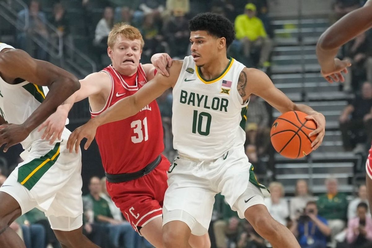 Jan 2, 2024; Waco, Texas, USA;  Baylor Bears guard RayJ Dennis (10) controls the ball against Cornell Big Red guard Cooper Noard (31) during the first half at Paul and Alejandra Foster Pavilion.