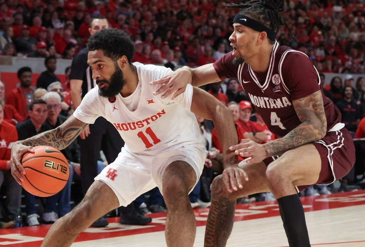 Nov 24, 2023; Houston, Texas, USA;  Houston Cougars guard Damian Dunn (11) dribbles against Montana Grizzlies guard Giordan Williams (4) in the first half at Fertitta Center.