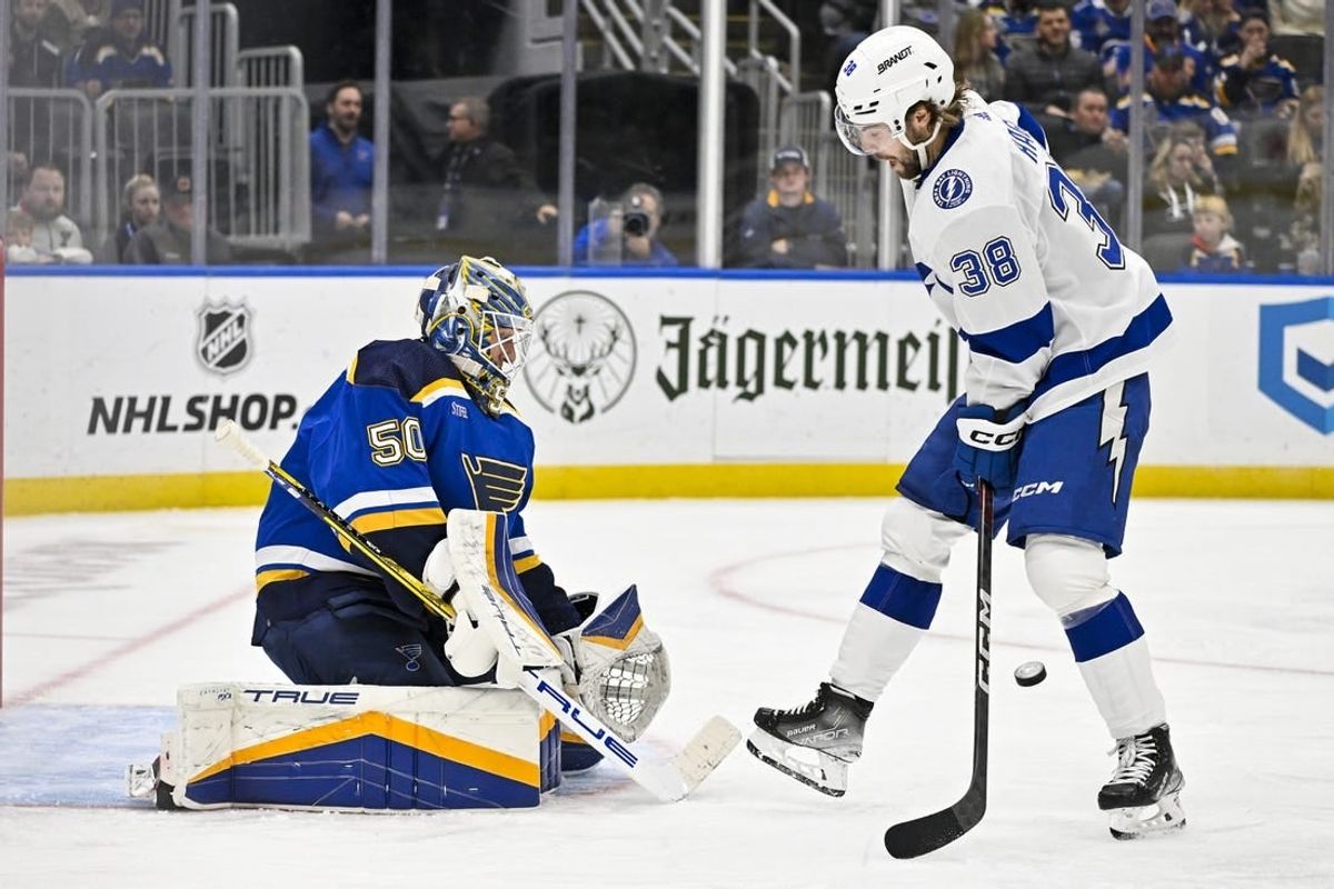 Nov 14, 2023; St. Louis, Missouri, USA;  St. Louis Blues goaltender Jordan Binnington (50) defends the net against Tampa Bay Lightning left wing Brandon Hagel (38) during the third period at Enterprise Center.