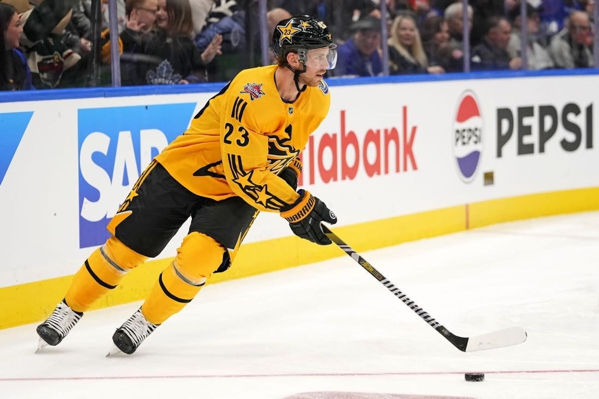 Feb 3, 2024; Toronto, Ontario, CAN; Team MacKinnon center Elias Lindholm (23) of the Vancouver Canucks moves the puck in the 2024 NHL All-Star Game at Scotiabank Arena.