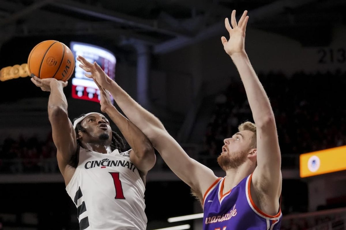 Dec 29, 2023; Cincinnati, Ohio, USA;  Cincinnati Bearcats forward Kalu Ezikpe (1) drives to the basket against Evansville Aces forward Joshua Hughes (11) in the first half at Fifth Third Arena.