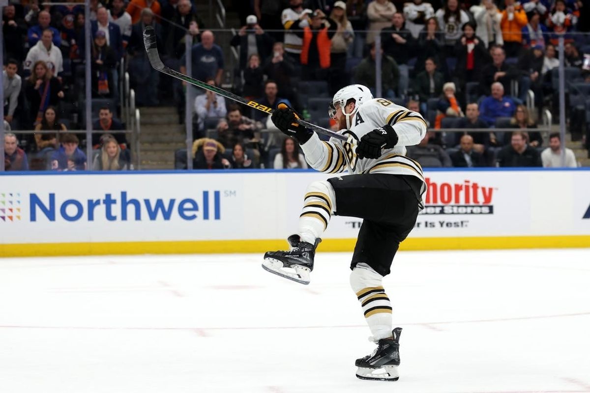 Dec 15, 2023; Elmont, New York, USA; Boston Bruins right wing David Pastrnak (88) follows through on the game winning goal during the shootout at UBS Arena.