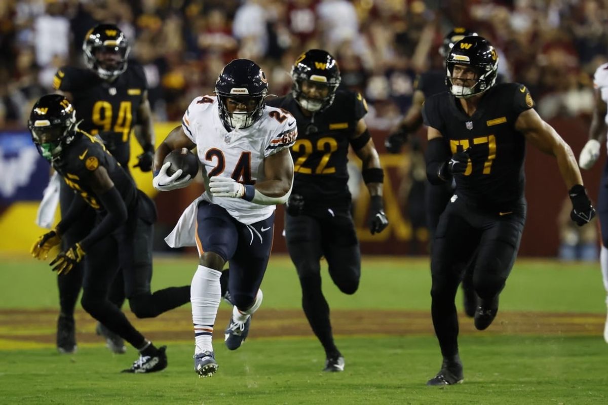 Oct 5, 2023; Landover, Maryland, USA; Chicago Bears running back Khalil Herbert (24) carries the ball as Washington Commanders linebacker Cody Barton (57) chases during the first quarter at FedExField.