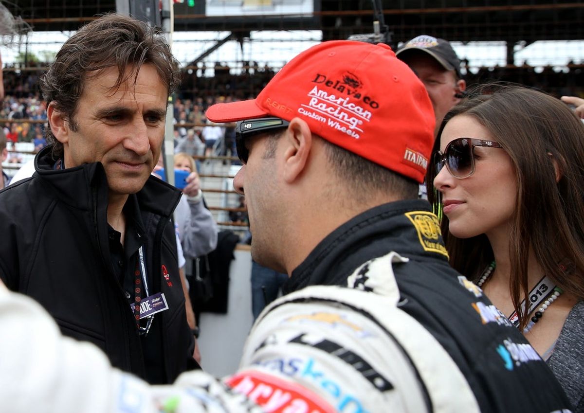 May 26, 2013; Indianapolis, IN, USA: Alex Zanardi (left) talks with IndyCar driver Tony Kanaan (center) and Lauren Kanaan prior to the Indianapolis 500 at the Indianapolis Motor Speedway. Mandatory Credit: Mark J. Rebilas-Imagn Images