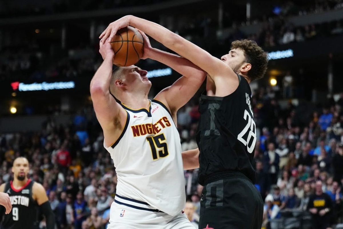 Dec 8, 2023; Denver, Colorado, USA; Houston Rockets center Alperen Sengun (28) blocks a shot by Denver Nuggets center Nikola Jokic (15) in the second half at Ball Arena.