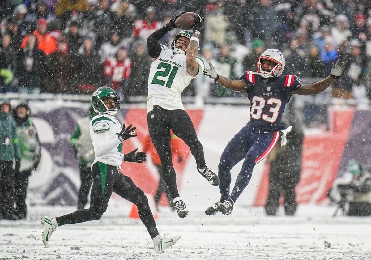 Jan 7, 2024; Foxborough, Massachusetts, USA; New York Jets safety Ashtyn Davis (21) intercepts a pass intended for New England Patriots wide receiver Jalen Reagor (83) in the second half at Gillette Stadium.