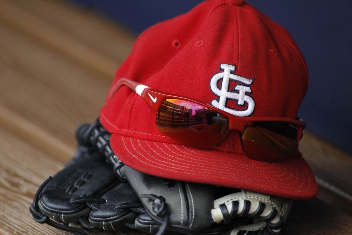 Detailed view of St. Louis Cardinals cap and glove. Mandatory Credit: Brett Davis-Imagn Images