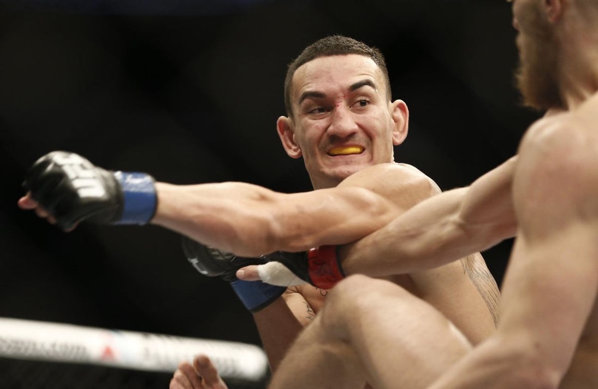 Aug 17, 2013; Boston, MA, USA; Max Holloway (left) throws a punch at Conor McGregor (right) during a UFC featherweight match at the TD Garden. McGregor won after three rounds by judges decision. Mandatory Credit: Winslow Townson-Imagn Images