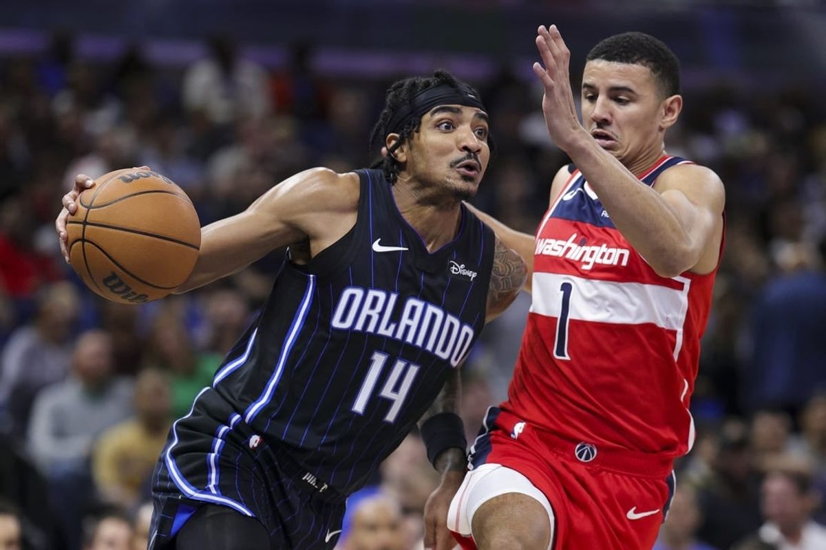 Dec 1, 2023; Orlando, Florida, USA;  Orlando Magic guard Gary Harris (14) drives to the basket past Washington Wizards guard Johnny Davis (1) in the second quarter at Amway Center.