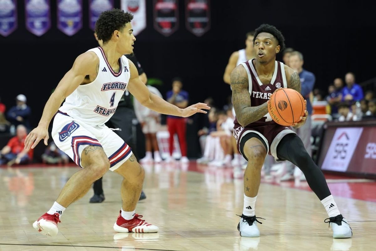 Nov 24, 2023; Kissimmee, FL, USA;  Texas A&M Aggies guard Wade Taylor IV (4) looks to shoot the ball guarded by Florida Atlantic Owls guard Bryan Greenlee (4) in the second half during the ESPN Events Invitational Semifinals at State Farm Field House.