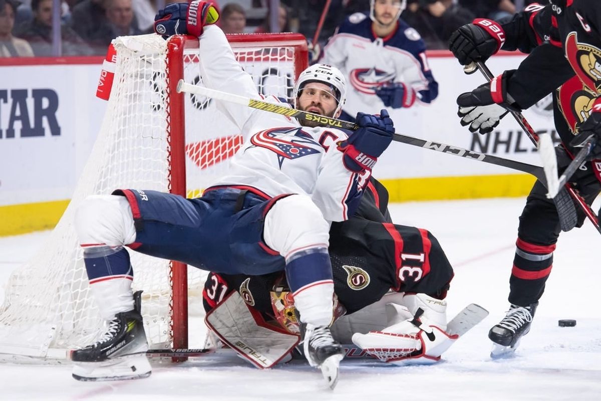 Feb 13, 2024; Ottawa, Ontario, CAN; Columbus Blue Jackets center Boone Jenner (38) falls on top of Ottawa Senators goalie Anton Forsberg (31)in a battle in the second period at the Canadian Tire Centre.