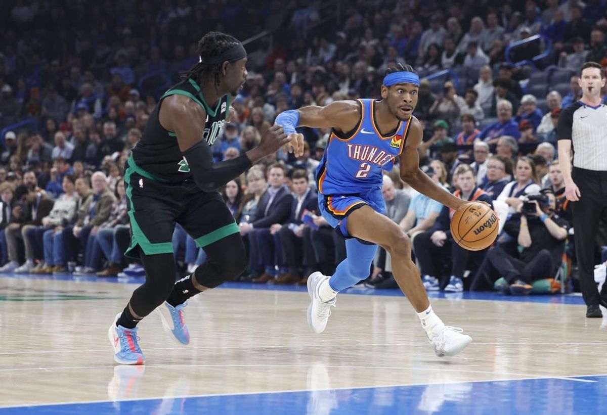 Jan 2, 2024; Oklahoma City, Oklahoma, USA; Oklahoma City Thunder guard Shai Gilgeous-Alexander (2) drives to the basket beside Boston Celtics guard Jrue Holiday (4) during the first quarter at Paycom Center.