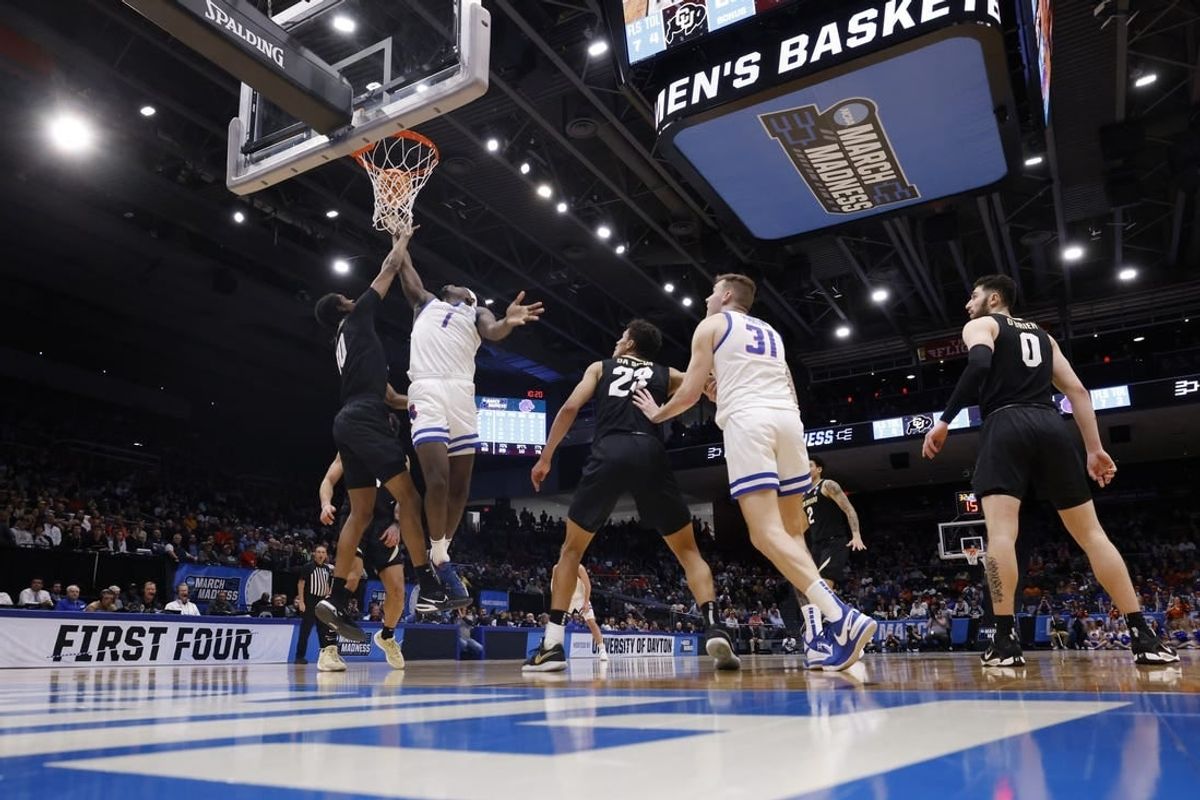 Mar 20, 2024; Dayton, OH, USA; Boise State Broncos forward O'Mar Stanley (1) goes to the basket defended by Colorado Buffaloes forward Cody Williams (10) in the first half at UD Arena.