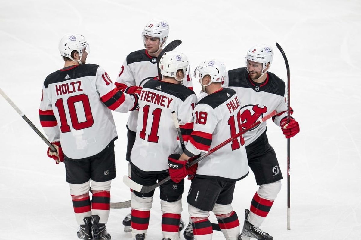 Feb 27, 2024; San Jose, California, USA;  New Jersey Devils right wing Alexander Holtz (10) and center Chris Tierney (11) and left wing Ondrej Palat (18) and defenseman Brendan Smith (2) and defenseman Simon Nemec (17) celebrate after the goal against the San Jose Sharks during the third period at SAP Center at San Jose.