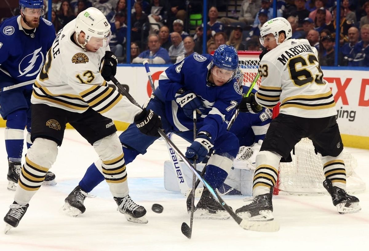 Mar 27, 2024; Tampa, Florida, USA; Tampa Bay Lightning defenseman Emil Martinsen Lilleberg (78) defends Boston Bruins center Charlie Coyle (13) and left wing Brad Marchand (63) during the second period at Amalie Arena.