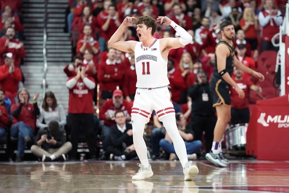Jan 13, 2024; Madison, Wisconsin, USA; Wisconsin Badgers guard Max Klesmit (11) gestures making a three point basket during the second half at the Kohl Center.