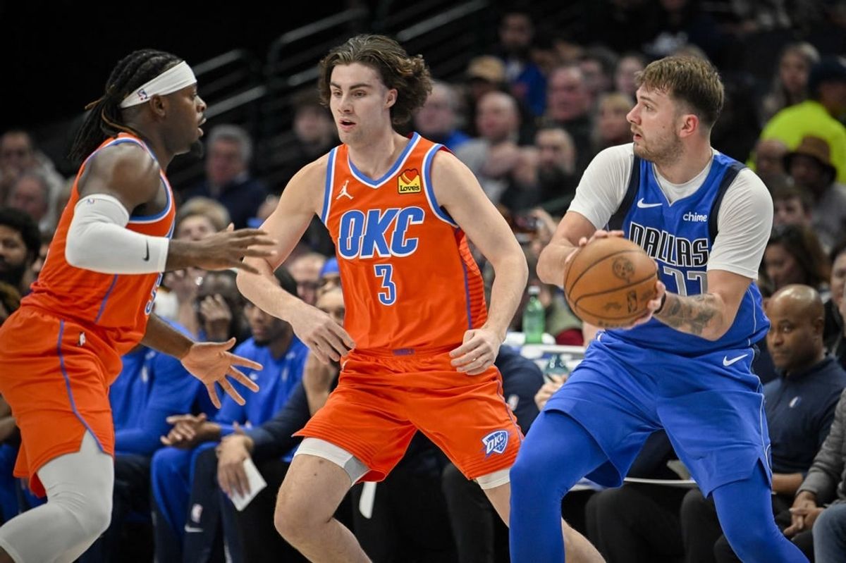 Dec 2, 2023; Dallas, Texas, USA; Dallas Mavericks guard Luka Doncic (77) looks to pass the ball past Oklahoma City Thunder guard Josh Giddey (3) during the second quarter at the American Airlines Center.