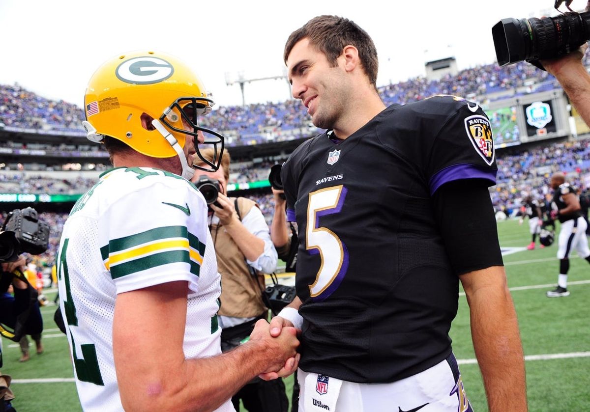 Still standing: Then-Packers QB Aaron Rodgers (12) shakes hands with then-Baltimore Ravens QB Joe Flacco (5) after a 2013 game. They're slated to start Thursday as over-age-40 QBs. Mandatory Credit: Evan Habeeb-Imagn Images