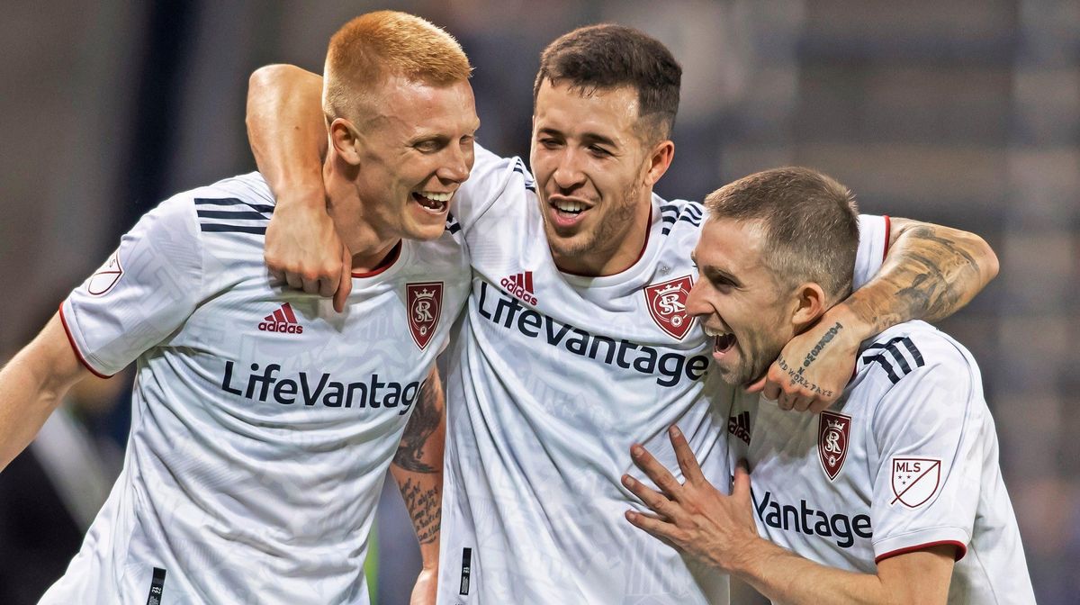 Real  Salt  Lake’s  Aaron  Herrera,  Justen  Glad ,  and  Andrew  Brody  celebrate  after  their  team’s  victory  over  Sporting  Kansas  City.