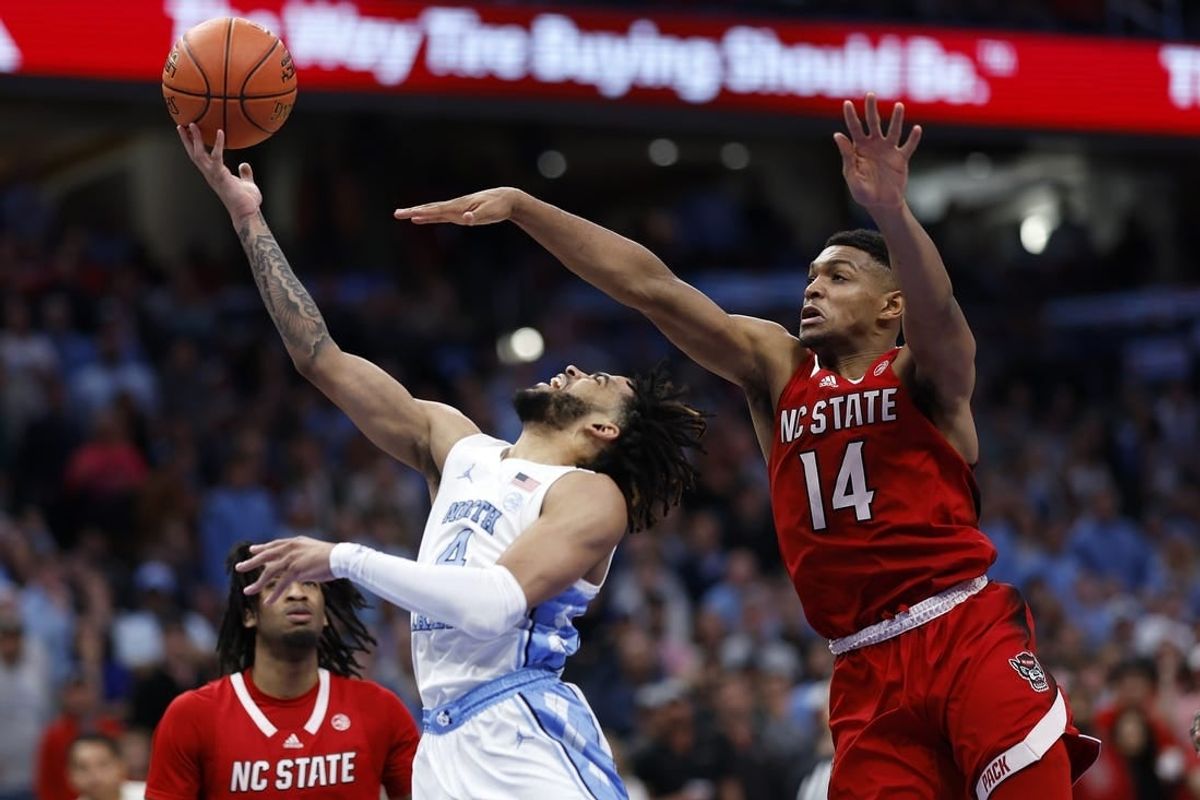 Mar 16, 2024; Washington, D.C., USA; North Carolina Tar Heels guard RJ Davis (4) shoots the ball against North Carolina State Wolfpack guard Casey Morsell (14) during the second half at Capital One Arena.